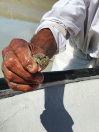 High angle view of man holding leaf
