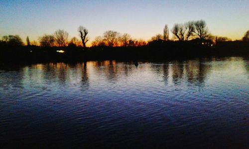 Scenic view of lake against sky at sunset