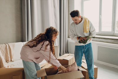 Side view of young woman working at home