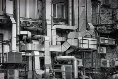 Low angle view of pipes on industrial building