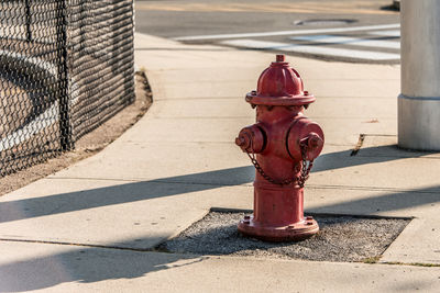 Red fire hydrant on footpath