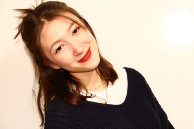 Portrait of a smiling young woman over white background