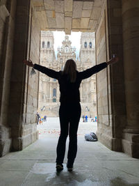 Rear view of woman standing in building