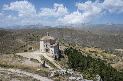 The church of santa maria della pietà in rocca calascio with the beautiful abruzzo mountains 