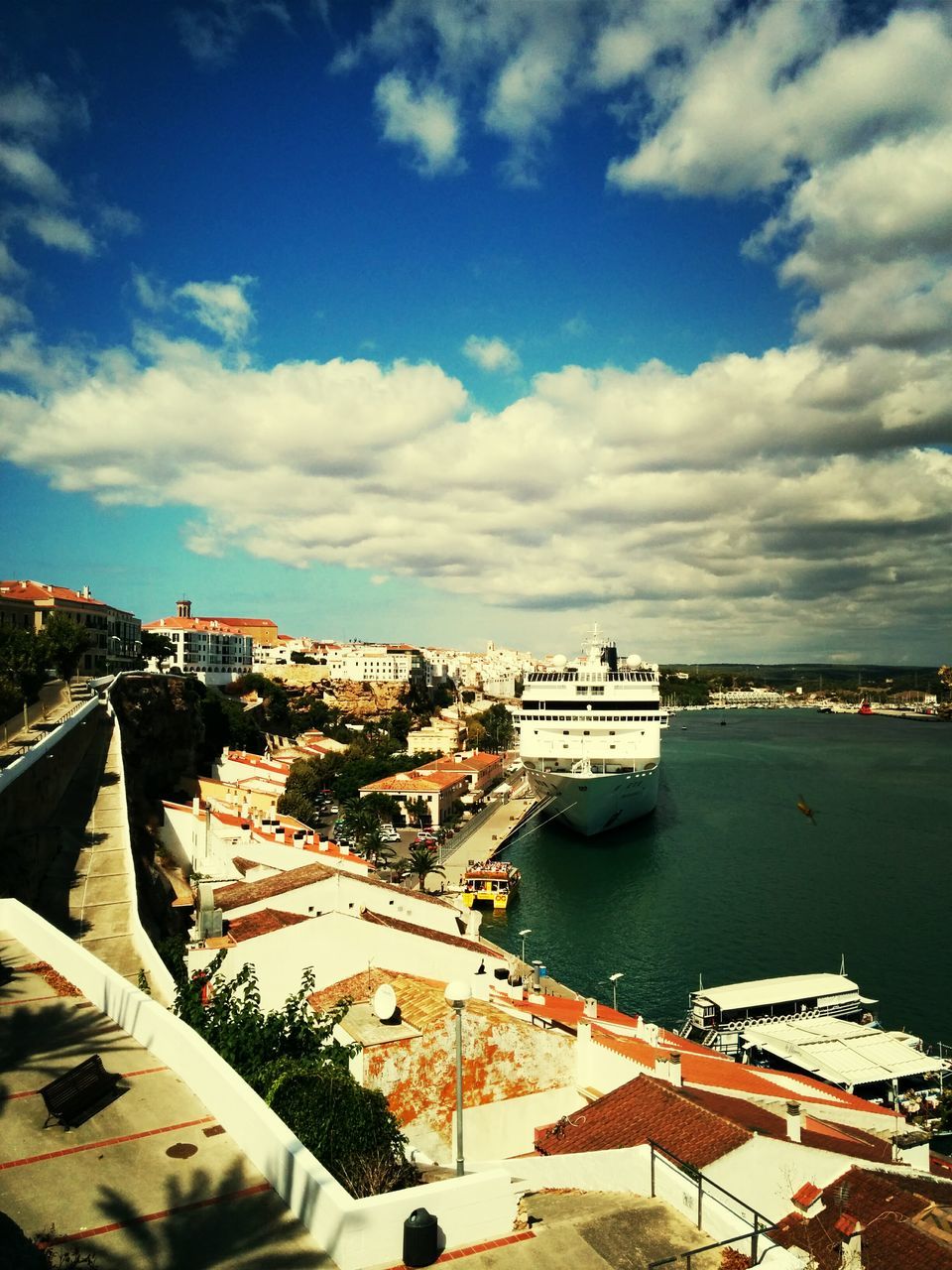 architecture, built structure, building exterior, water, sky, cloud - sky, high angle view, city, nautical vessel, transportation, sea, cloud, river, town, cityscape, day, cloudy, residential structure, outdoors, mode of transport