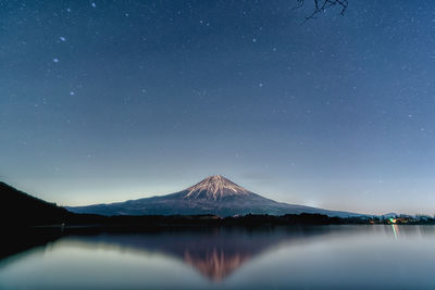 Scenic view of snowcapped mountains against sky at night