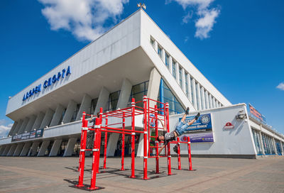 Low angle view of building under construction against blue sky