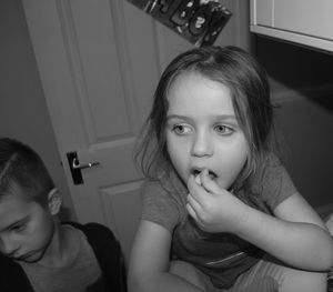 Close-up of young woman sitting at home