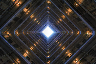 Low angle view of illuminated building against sky at night