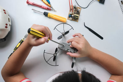 Cropped hands of man working on table