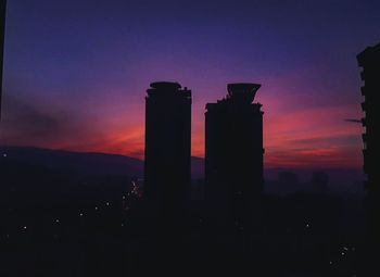 Silhouette of buildings against sky during sunset