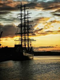Sailboat sailing on sea against sky during sunset