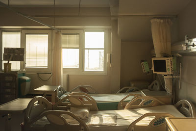 Empty chairs and table by window at home