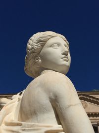 Low angle view of statue against blue sky
