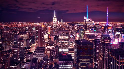 High angle view of city lit up at night