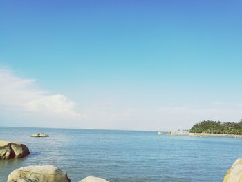 Scenic view of sea against blue sky