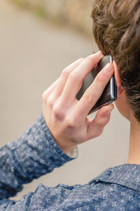 Midsection of man using mobile phone