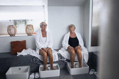 Senior women having footbath in spa