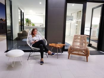 Rear view of woman sitting on chair