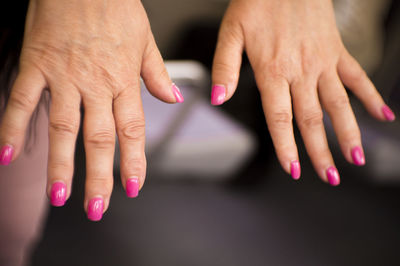 Close-up of woman hand with pink nail polish