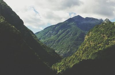 Scenic view of mountains against cloudy sky