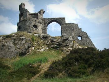 Low angle view of abandoned castle against sky