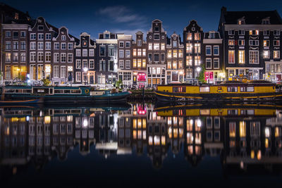 Reflection of illuminated buildings in canal at night