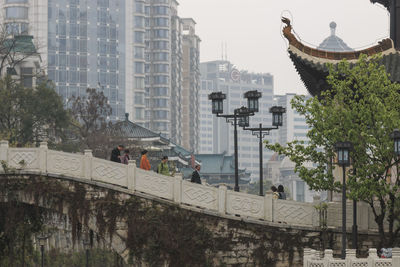 People in city against buildings