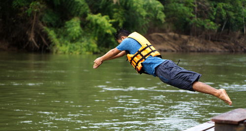 Side view of man diving in lake