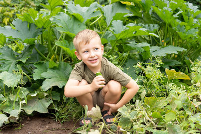 Portrait of smiling boy with plants