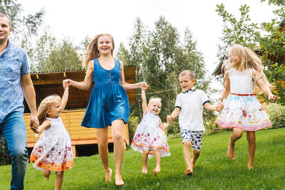 Full length of a smiling girl standing on grass