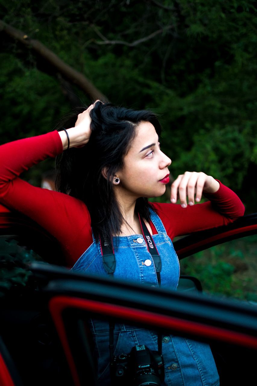 one person, young adult, real people, leisure activity, looking, young women, looking away, casual clothing, lifestyles, front view, contemplation, hair, women, portrait, day, focus on foreground, waist up, black hair, hairstyle, outdoors, beautiful woman