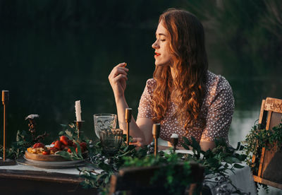 Young woman sitting on table