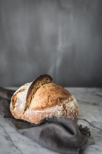 Close-up of bread on table against white background