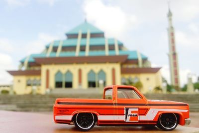 Close-up of red car against sky