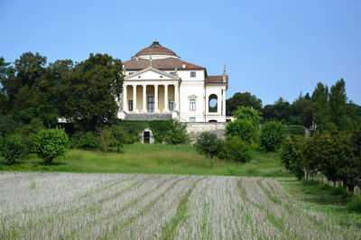 House by trees against clear sky