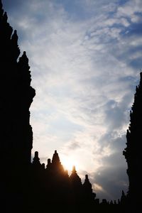 Silhouette temple against sky at sunset