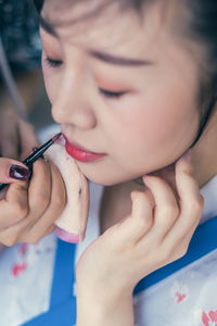 Close-up portrait of woman holding hands