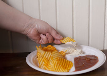 Midsection of woman holding ice cream in plate