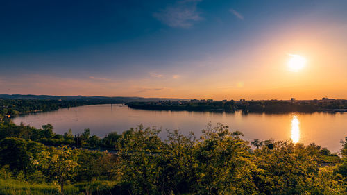 Scenic view of lake against sky during sunset