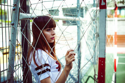 Young woman standing in goal post