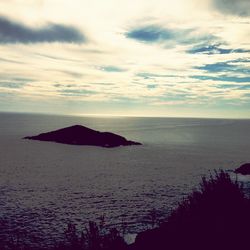 Scenic view of sea against cloudy sky