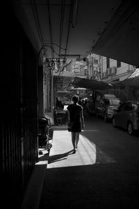 Rear view of woman walking on street