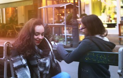 Portrait of young woman in illuminated park