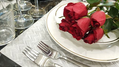 High angle view of red roses on table