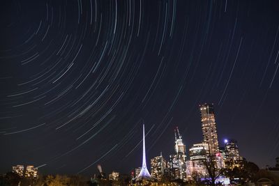 Low angle view of illuminated buildings against sky at night