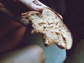 Midsection of man holding bread