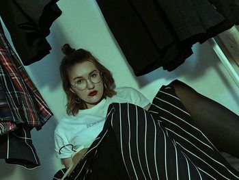 Portrait of young woman lying on bed