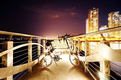 Illuminated bridge against sky in city at night