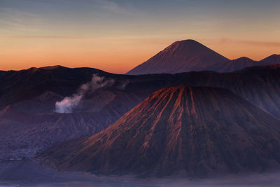 Scenic view of snowcapped mountains against sky during sunset